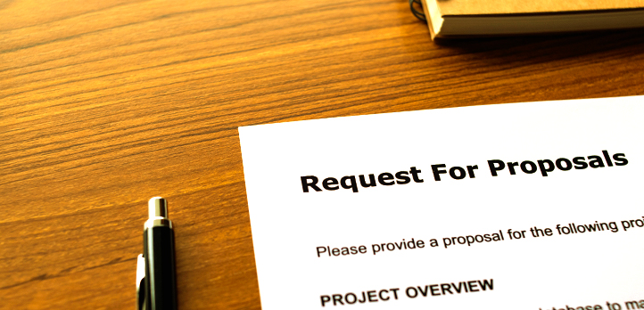 Paper on the desk with the heading "Request For Proposals"